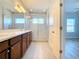 The bathroom features a walk-in shower with a glass door and marble tile at 869 Taramundi Dr, Oviedo, FL 32765