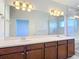 Bathroom with double vanity, large mirror, and marble walk-in shower at 869 Taramundi Dr, Oviedo, FL 32765