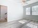 Bright bedroom features light wood floors, ceiling fan, and windows that allow natural light at 869 Taramundi Dr, Oviedo, FL 32765