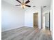 This bedroom has wood-look floors, a ceiling fan, and a walk-in closet at 869 Taramundi Dr, Oviedo, FL 32765