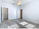 Bright bedroom with wood-look floors features a ceiling fan, walk-in closet, and white trim at 869 Taramundi Dr, Oviedo, FL 32765