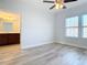 Bedroom boasts natural light, wood-look flooring, and an attached bathroom at 869 Taramundi Dr, Oviedo, FL 32765