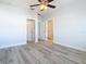 Bright bedroom features a ceiling fan, neutral paint, and wood-look flooring at 869 Taramundi Dr, Oviedo, FL 32765