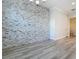 Dining room features stone accent wall, base trim, and view to powder room at 869 Taramundi Dr, Oviedo, FL 32765