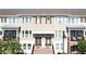 Well-maintained townhome exteriors show brick stairs, neutral colors, and manicured landscaping in a vibrant community at 869 Taramundi Dr, Oviedo, FL 32765