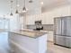 Open kitchen features granite countertops, a center island and stainless steel appliances at 869 Taramundi Dr, Oviedo, FL 32765