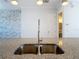 Kitchen island with granite countertop, stainless steel sink, and pull down faucet at 869 Taramundi Dr, Oviedo, FL 32765