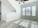 Bright living room with modern gray flooring and lots of windows for natural light at 869 Taramundi Dr, Oviedo, FL 32765