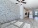 Open floor plan showcasing the living room and modern kitchen with stone accent wall at 869 Taramundi Dr, Oviedo, FL 32765