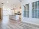 Open concept living area leads to the kitchen, with modern gray plank floors at 869 Taramundi Dr, Oviedo, FL 32765