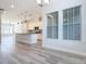 Open concept living and kitchen area, with modern gray plank floors at 869 Taramundi Dr, Oviedo, FL 32765