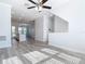 Open-concept home showcasing the living room and kitchen with gray modern flooring at 869 Taramundi Dr, Oviedo, FL 32765
