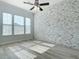Spacious living room featuring a stylish accent wall and natural light at 869 Taramundi Dr, Oviedo, FL 32765