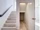 Staircase leads to a bonus room and features wood-look steps at 869 Taramundi Dr, Oviedo, FL 32765