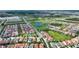 Scenic aerial shot of a residential neighborhood featuring red-tiled roofs and community green spaces at 8872 Bismarck Palm Dr, Winter Garden, FL 34787