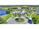 Aerial view of community clubhouse overlooking golf course, lakes, and manicured landscaping at 8872 Bismarck Palm Dr, Winter Garden, FL 34787