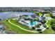 Stunning aerial view of a community pool and clubhouse, surrounded by palm trees and manicured landscaping at 8872 Bismarck Palm Dr, Winter Garden, FL 34787
