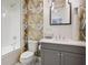 Charming bathroom featuring a tub-shower combination, modern vanity, and stylish wallpaper at 8872 Bismarck Palm Dr, Winter Garden, FL 34787