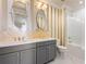 Elegantly appointed bathroom with double vanity, dual mirrors and a shower-tub combo at 8872 Bismarck Palm Dr, Winter Garden, FL 34787