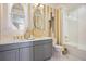 Elegant bathroom with double vanity, gold fixtures, and a glass-enclosed shower at 8872 Bismarck Palm Dr, Winter Garden, FL 34787