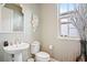 Elegant bathroom features patterned wallpaper, stylish fixtures, and a decorative mirror at 8872 Bismarck Palm Dr, Winter Garden, FL 34787