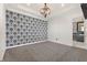 Spacious bedroom with bold wallpaper and modern patterned carpet at 8872 Bismarck Palm Dr, Winter Garden, FL 34787