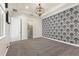 Bedroom featuring patterned wallpaper, stylish carpet and lighting, with a walk-in closet at 8872 Bismarck Palm Dr, Winter Garden, FL 34787