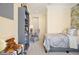 Bright bedroom features a twin bed, bookcase and desk, with stylish grey and yellow decor at 8872 Bismarck Palm Dr, Winter Garden, FL 34787