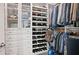 Organized walk-in closet with custom shelving, drawers, and clothing racks at 8872 Bismarck Palm Dr, Winter Garden, FL 34787