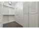 Custom closet featuring white cabinetry, storage space, and patterned carpet at 8872 Bismarck Palm Dr, Winter Garden, FL 34787