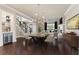 Elegant dining room featuring hardwood floors, a contemporary chandelier, and seamless access to the living room at 8872 Bismarck Palm Dr, Winter Garden, FL 34787