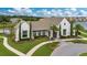 Exterior view of a modern-style community clubhouse featuring a tile roof, lush landscaping and brick walkway at 8872 Bismarck Palm Dr, Winter Garden, FL 34787