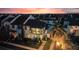 Gorgeous sunset view of a two-story home with a balcony and lush landscaping at 8872 Bismarck Palm Dr, Winter Garden, FL 34787