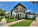 Charming two-story townhome featuring a balcony with flower boxes and professionally landscaped front yard at 8872 Bismarck Palm Dr, Winter Garden, FL 34787