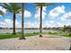 Relaxing hammock strung between palm trees on a sandy lakeside beach at 8872 Bismarck Palm Dr, Winter Garden, FL 34787