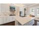 Well-equipped kitchen featuring granite countertops, an island with bar seating, and stainless steel appliances at 8872 Bismarck Palm Dr, Winter Garden, FL 34787
