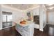 Contemporary kitchen with white cabinets, stone island, stainless steel appliances and hardwood floors at 8872 Bismarck Palm Dr, Winter Garden, FL 34787