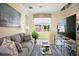 Comfortable living room with a gray sofa, large TV, and bright natural light at 8872 Bismarck Palm Dr, Winter Garden, FL 34787