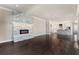 Spacious living room with fireplace and open concept layout into kitchen with hardwood flooring at 8872 Bismarck Palm Dr, Winter Garden, FL 34787