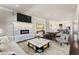 Bright living room featuring a stone fireplace with a TV, modern furnishings, and an open floor plan at 8872 Bismarck Palm Dr, Winter Garden, FL 34787