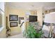 View of the living room with mirrored cabinet below large screen TV at top of the stairs at 8872 Bismarck Palm Dr, Winter Garden, FL 34787