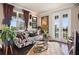 Stylish living room with patterned sofa, modern decor, and sliding doors to outdoor space at 8872 Bismarck Palm Dr, Winter Garden, FL 34787