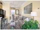 Cozy living room features a grey sofa, glass coffee table and a nearby dining area with seating for four at 8872 Bismarck Palm Dr, Winter Garden, FL 34787