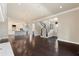 Bright, open living space with hardwood floors, modern lighting, and seamless flow to the kitchen and staircase at 8872 Bismarck Palm Dr, Winter Garden, FL 34787
