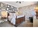 Bedroom with a dark wood bed frame, accent wall, and unique decor elements at 8872 Bismarck Palm Dr, Winter Garden, FL 34787