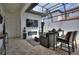 Covered patio featuring a fireplace, TV, comfortable seating, and an outdoor bar at 8872 Bismarck Palm Dr, Winter Garden, FL 34787
