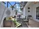 Inviting outdoor living space with a glass roof, comfortable seating, and a built-in grill at 8872 Bismarck Palm Dr, Winter Garden, FL 34787