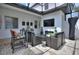 Stylish screened patio with comfortable seating, an outdoor fireplace, and a TV at 8872 Bismarck Palm Dr, Winter Garden, FL 34787