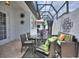 A beautiful patio area with wicker furniture, a glass roof, and brick flooring at 8872 Bismarck Palm Dr, Winter Garden, FL 34787
