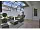 Cozy screened patio featuring comfortable seating, perfect for relaxing and entertaining at 8872 Bismarck Palm Dr, Winter Garden, FL 34787